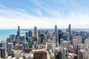 Academic Approach Tutoring and Test Prep | Aerial view of downtown Chicago with skyscrapers, Lake Michigan on the left, and a partly cloudy sky.