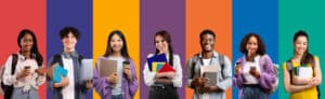 Academic Approach Tutoring and Test Prep | Seven diverse students stand in a row, smiling and holding books, notebooks, coffee, and backpacks, against a vibrant striped background with red, purple, orange, yellow, blue, and green colors.
