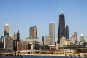 Academic Approach Tutoring and Test Prep | Chicago skyline with modern skyscrapers and the John Hancock Center, viewed from across a body of water on a clear, sunny day.